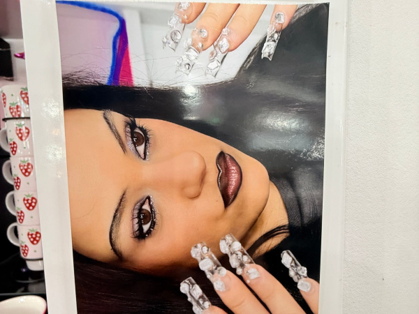 A photo of of a photo of singer Rosalia in her Euphoria makeup look  hanging inside the Euphoria season 3 makeup trailer.